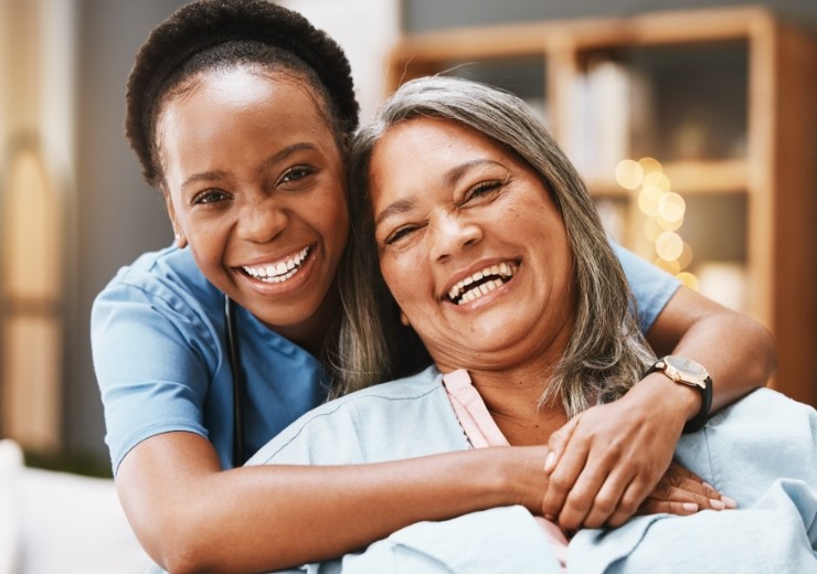 Compassionate caregiver assisting an elderly person at home in Bucks County, ensuring comfort and well-being through personalized home care services.