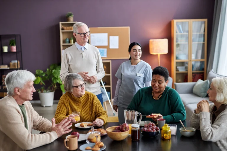 Seniors enjoying breakfast together with a caregiver at a day care centre in Montgomery County, PA.