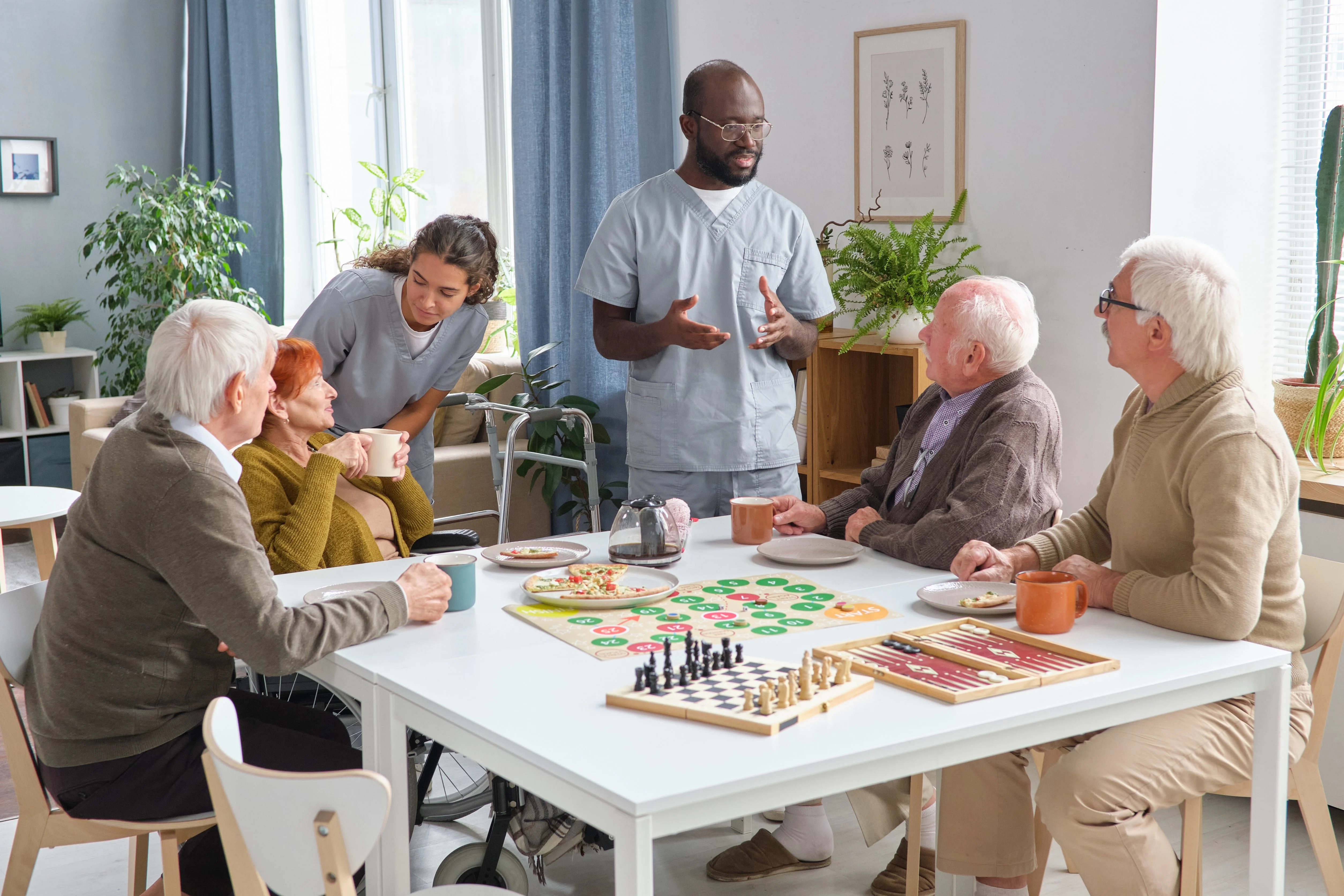 Seniors socializing and playing board games with caregivers at an elderly day care centre in Montgomery.