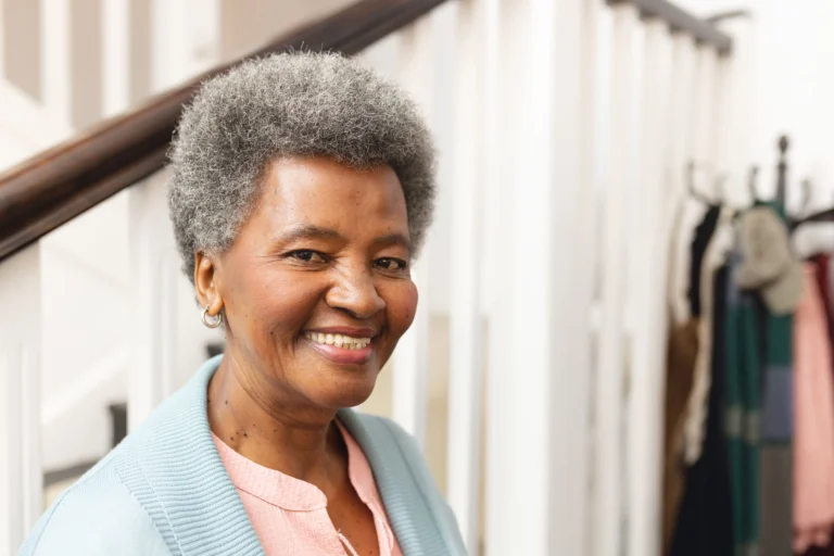 Happy elderly woman feeling confident and supported as part of a personalized care plan at home.