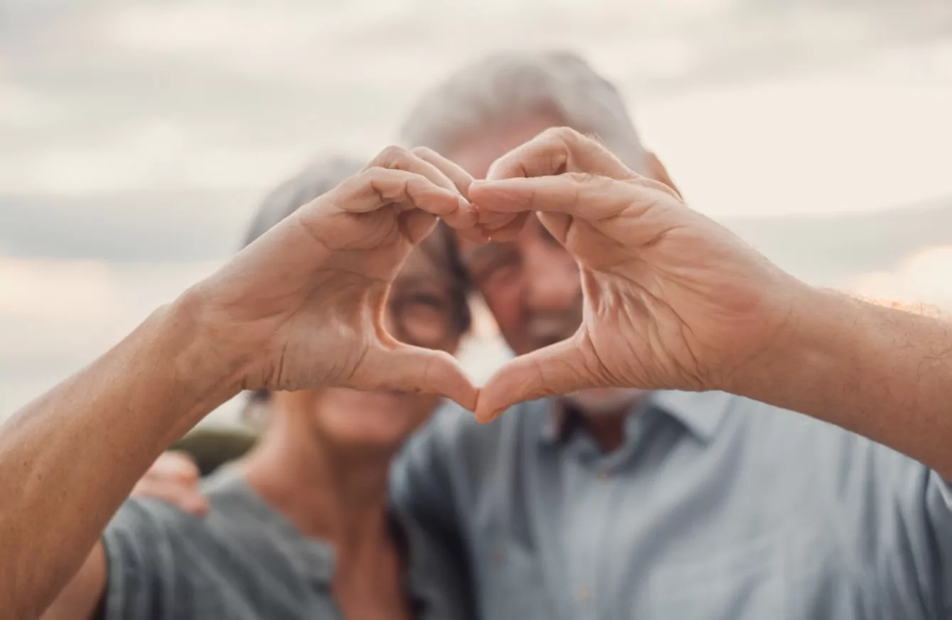 two seniors making heart sign
