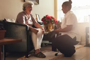 old lady at home with caretaker